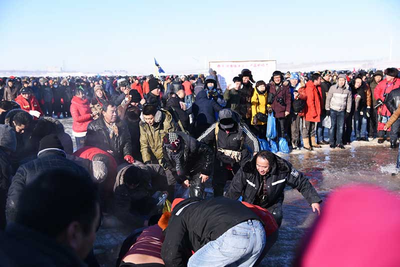Зимняя рыбалка на озере Чжагань: туристы сражаются за рыбу в ледяной воде