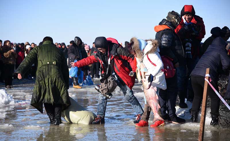 Зимняя рыбалка на озере Чжагань: туристы сражаются за рыбу в ледяной воде