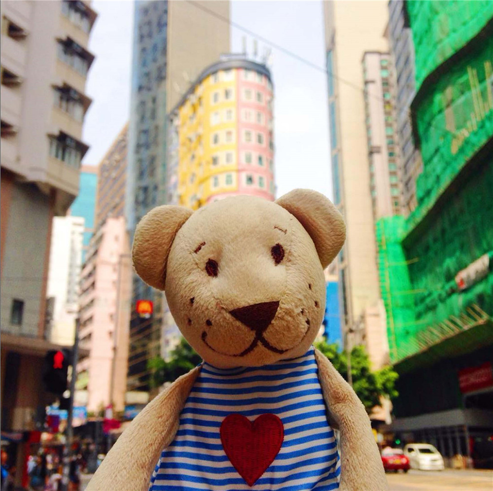 Медвежонок на фоне разноцветных зданий Гонконга, июль 2016.
