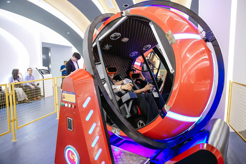 На фото: Посетители играют в машине времени с «технологией виртуальной реальности 720°».