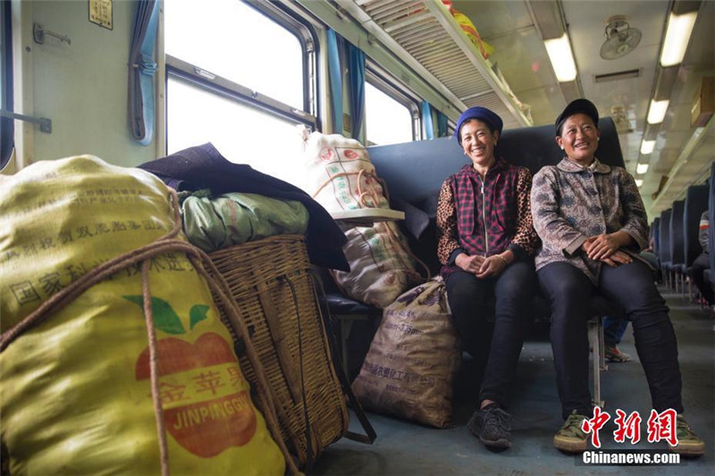 На фото: 5 июля две женщины народности И едут на поезде №5633 из города Пусюн в Паньчжихуа провинции Сычуань, они собираются торговать картофелем в городе Сидэ. 