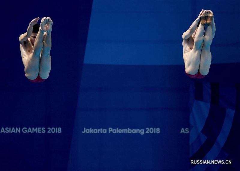 18-е Азиатские игры -- Синхронные прыжки в воду /3 м/ среди мужчин: китайские спортсмены Цао Юань и Се Сыи заняли первое место