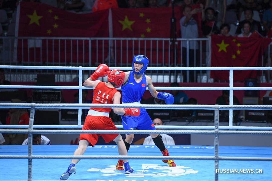 18-е Азиатские игры -- Бокс в весовой категории 57 кг /женщины/: китайская спортсменка Инь Цзюньхуа взяла "золото"