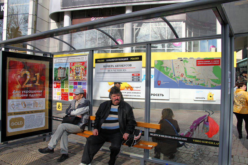 Автобусная остановка в центре Сочи, внутри которой наклеены карта города и автобусные маршруты.