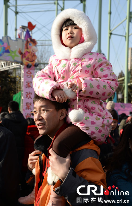 2 февраля отец с дочерью на плечах на храмовых гуляньях. Они наслаждаются закусками и восхищаются представлениями. 